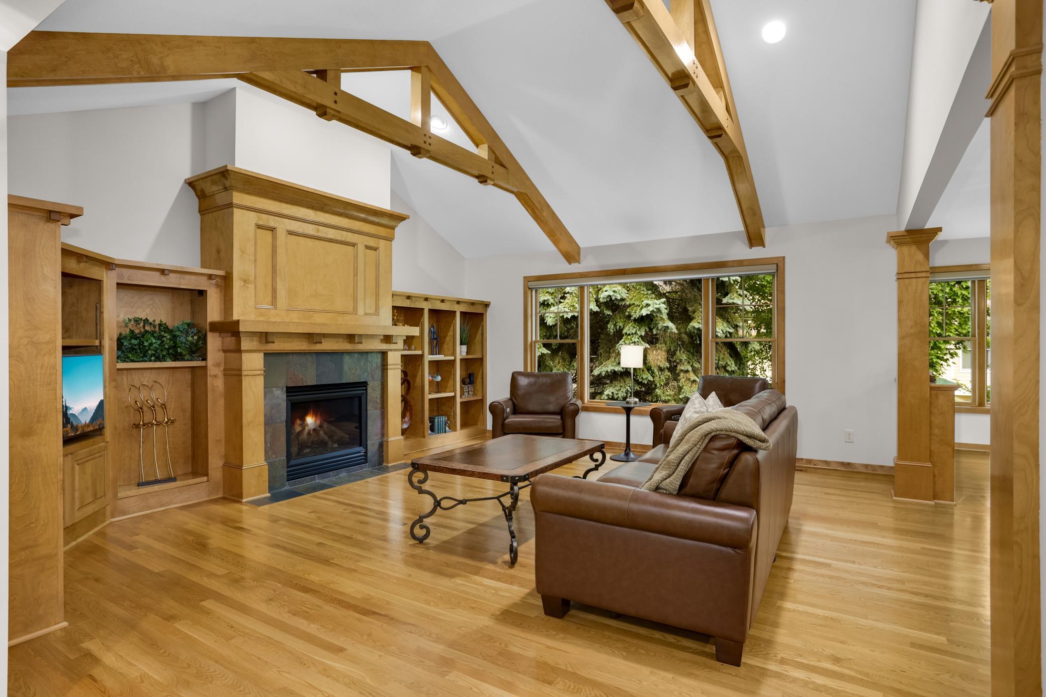 Large Anderson windows throughout the home fills the spaces with natural light and offers beautiful views of the surrounding mature trees.