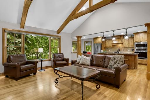 Beautiful open-concept living and kitchen area featuring rich knotty alder cabinetry, Cambria countertops, and a warm, inviting gathering space.