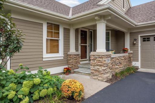 Impressive front entrance framed by striking stone pillars, creating a grand and welcoming first impression.