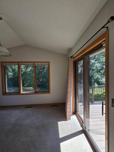 Sun Room Walks out to a spacious deck with stairs to Back Yard!