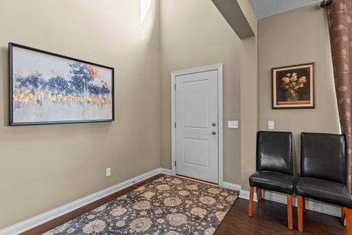 A beautiful chandelier makes a striking statement in the impressive two-story front entry.