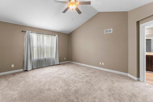 Primary bedroom with vaulted ceilings—an impressive feature that would cost significantly more to add to a new-construction home.
