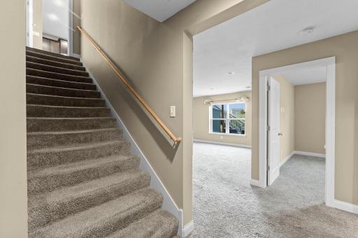 Wide, staircase leading to the lower-level walkout.