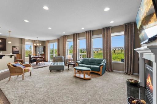 A wall of windows fills the living room with abundant natural light.