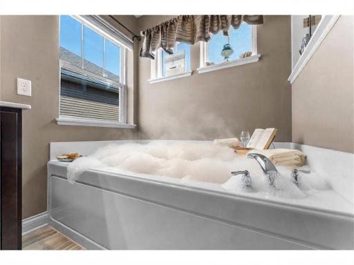 Relax for a soak in your luxurious tub. Virtually staged.
