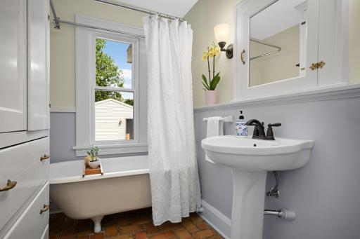 Main floor full bathroom with updated fixtures and wonderful built-in storage.