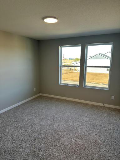 This secondary bedroom has a large walk in closet of a similar Duncan end home
