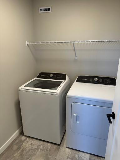 The second-floor laundry includes the washer and dryer in a similar Duncan end home