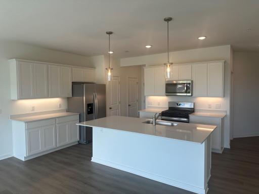Kitchen with large center island and gas range.jpg