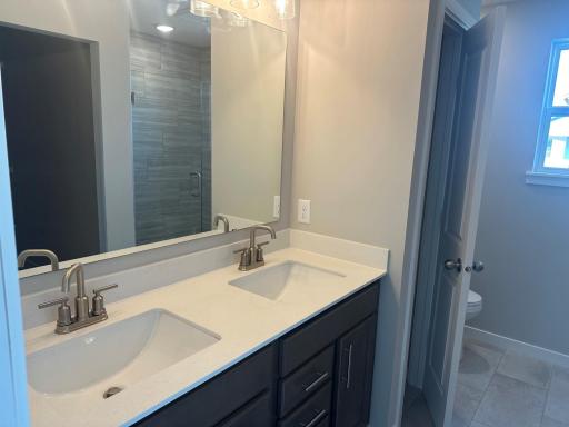 Primary Bath with Linen closet and Tiled Shower.jpg