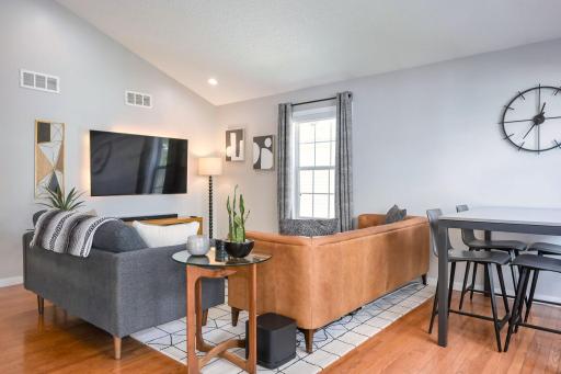 Bright, open living and dining space with hardwood floors