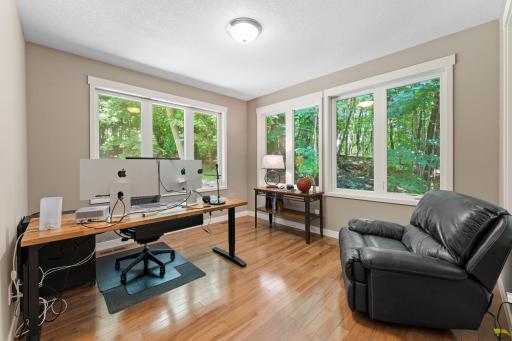 Sunroom, currently used as an office, with tranquil views!