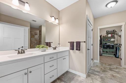 Primary spa-like bath with dual sinks and a separate toilet room