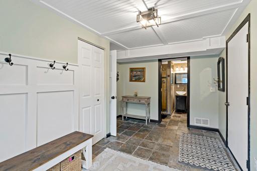 Large mudroom off garage and bathroom.