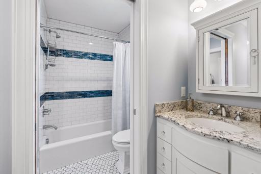 Separate tub and stool area in full bath.