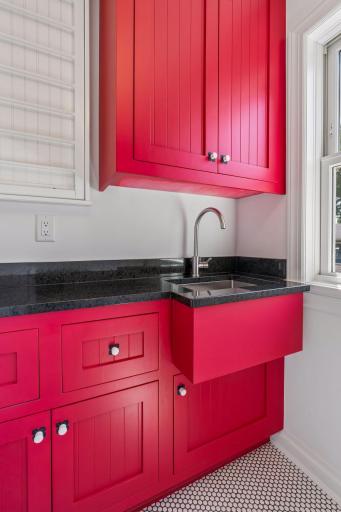 Upper level laundry room with built-in cabinetry.