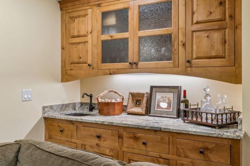 Lower level wet bar with built-in cabinetry.