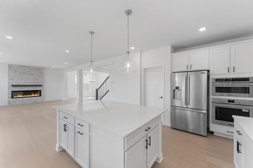 (Photo of a similar home, actual finishes may vary) The kitchen overlooks the open layout for easy entertaining