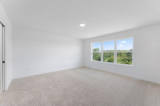 (Photo of a similar home, actual finishes may vary) The owner’s suite is a lavish haven on the top floor, hosting a large bedroom, en-suite bathroom and walk-in closet.