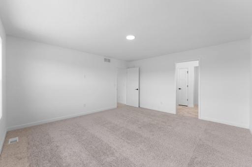 (Photo of a similar home, actual finishes may vary) The bedroom has direct access to the private bathroom