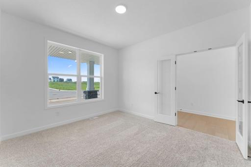 (Photo of a similar home, actual finishes may vary) French doors seclude this study from the rest of the first floor, creating an environment ideal for work productivity.