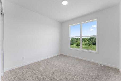 (Photo of a similar home, actual finishes may vary) There are three secondary bedrooms on the second floor, offering household members privacy and space to rest.