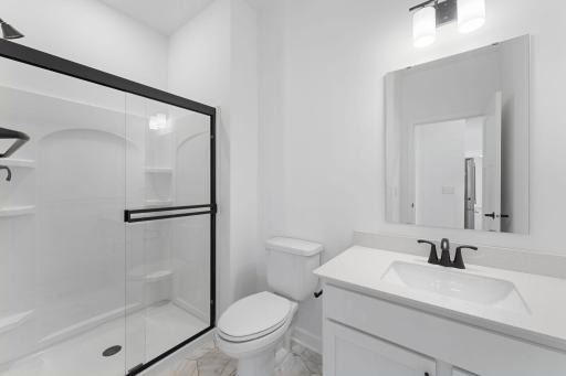 (Photo of a similar home, actual finishes may vary) Adjacent bath on the main level