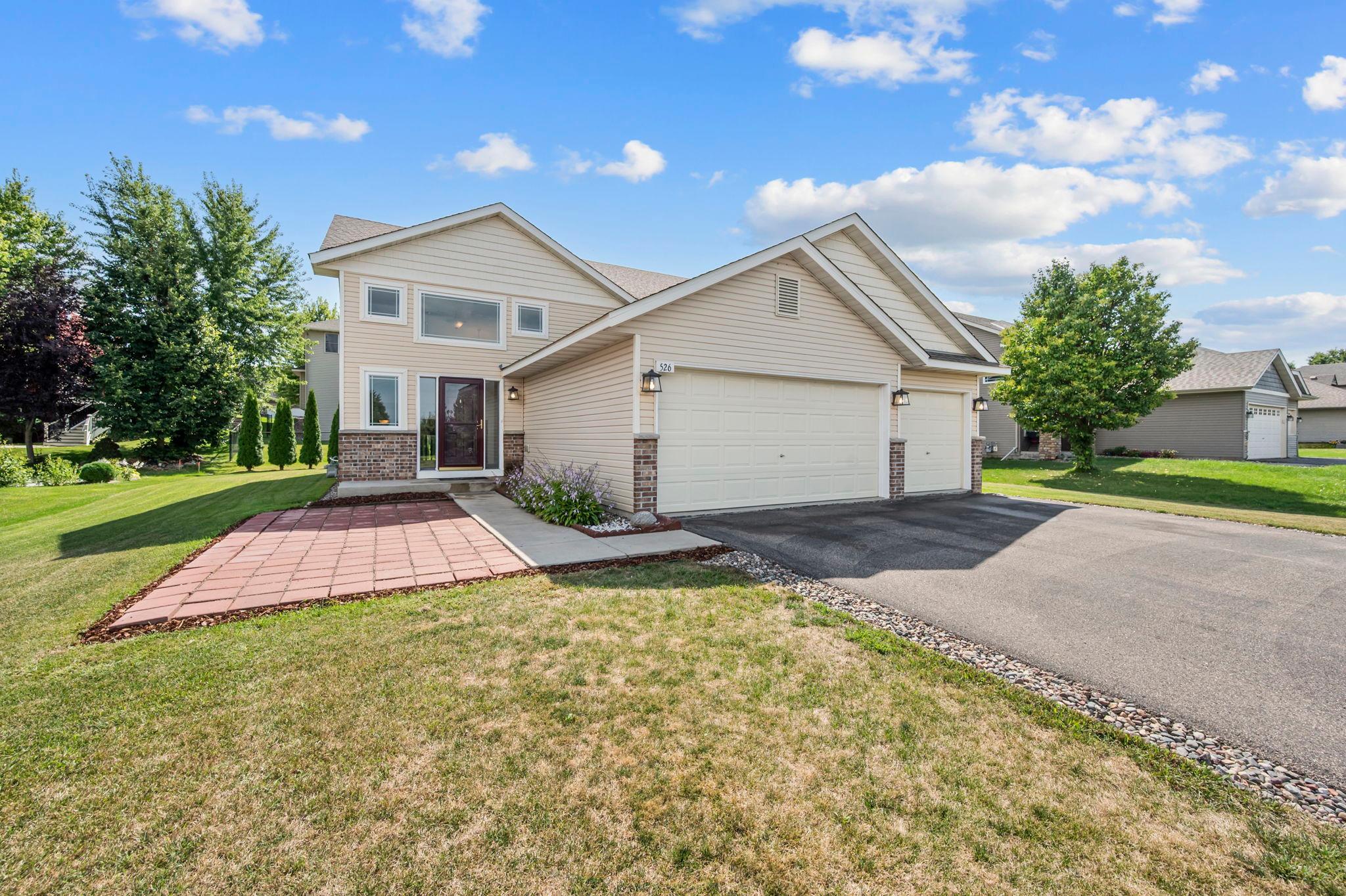 This home features a 3-car garage, wide asphalt driveway and large front patio for entertaining.