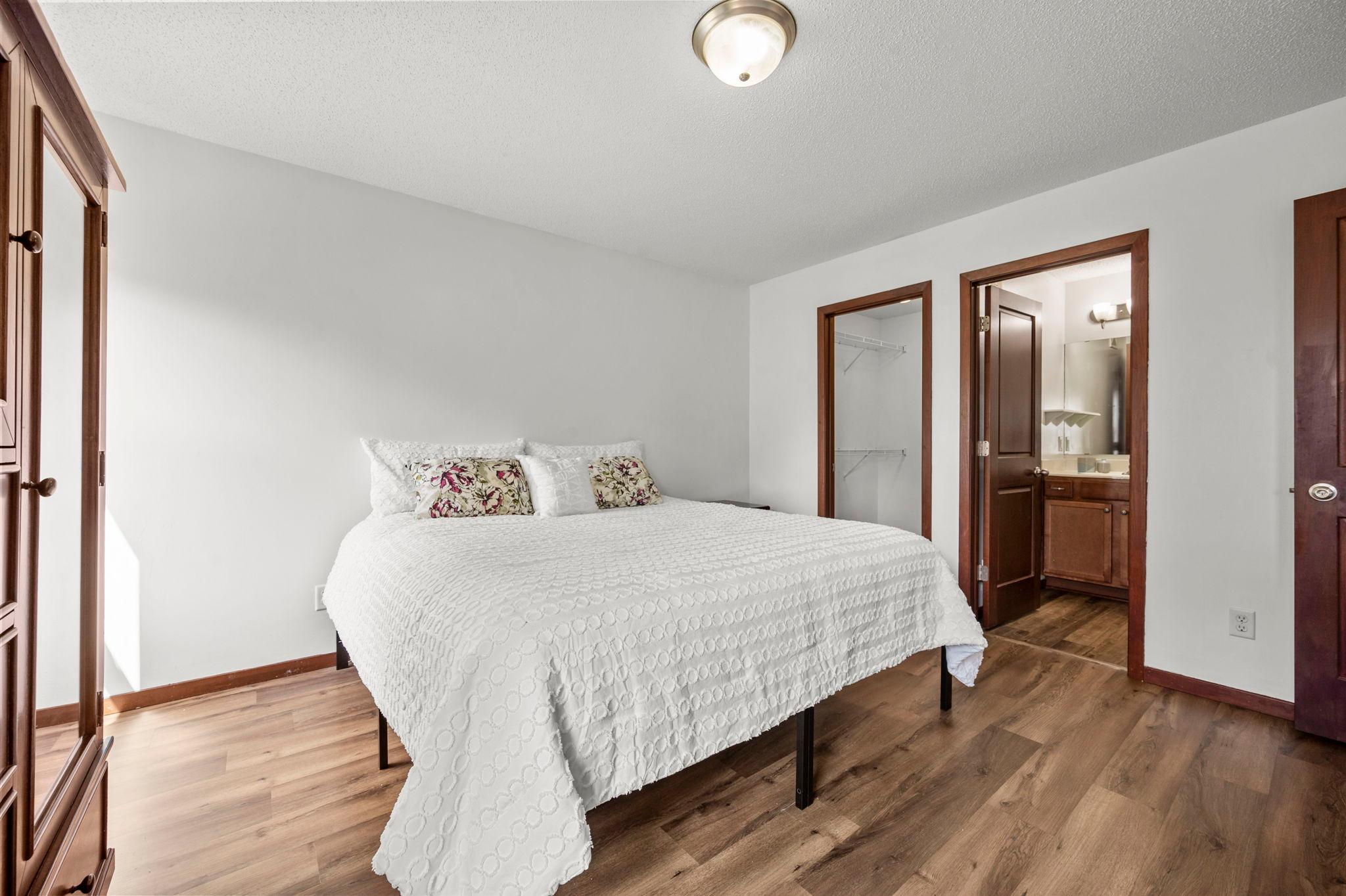 A spacious primary suite with walk-in closet and ensuite bathroom.