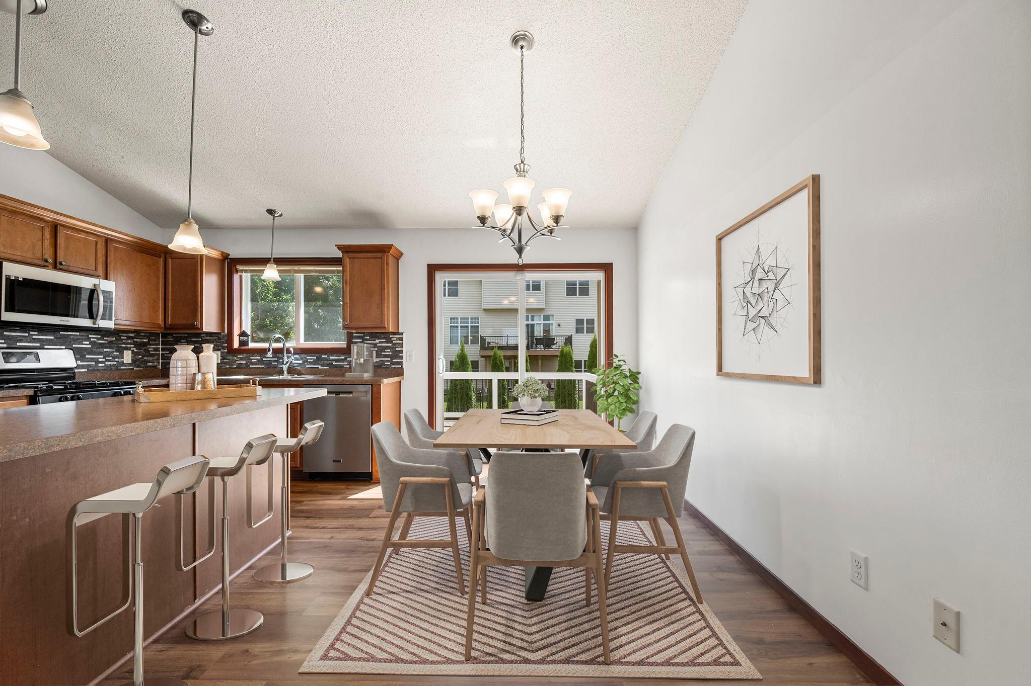 Virtually staged. There is plenty of space for both a dining room table and more relaxed seating at the kitchen island.