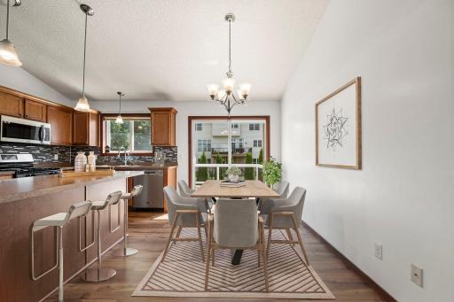 Virtually staged. There is plenty of space for both a dining room table and more relaxed seating at the kitchen island.