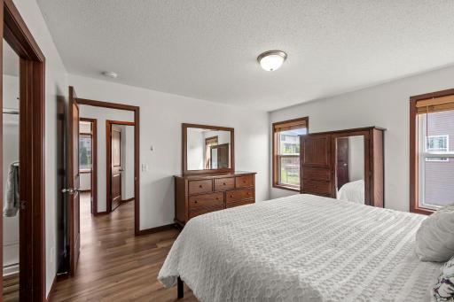 The primary bedroom windows have high quality plantation style wood blinds.