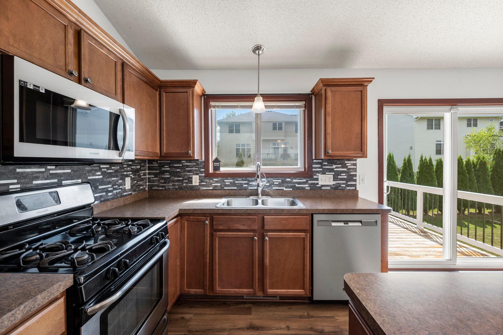 The kitchen has plenty of cabinets and counter space for meal prep.