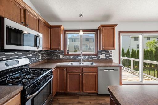 The kitchen has plenty of cabinets and counter space for meal prep.