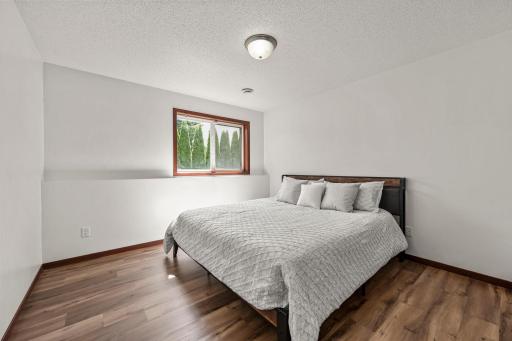 This is the first of two spacious bedrooms on the lower level. Both have large windows that look out to the backyard. This is king size bed.
