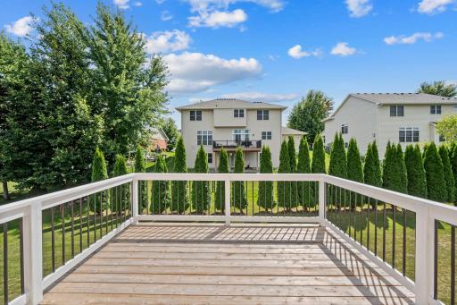 12 ft x 11 ft deck off of the kitchen. The row of evergreens belong to this property and offer some shade and privacy for the home.