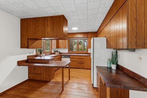 The midcentury modern kitchen has ample storage and counterspace with lots of natural light.