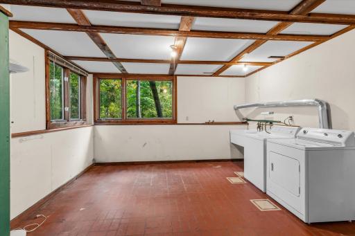 The laundry room with a sink has great space for a workshop or additional storage area.