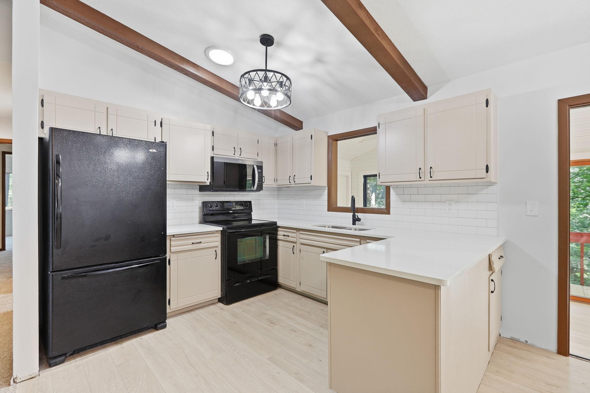 Sparkling new quartz countertops and tile backsplash