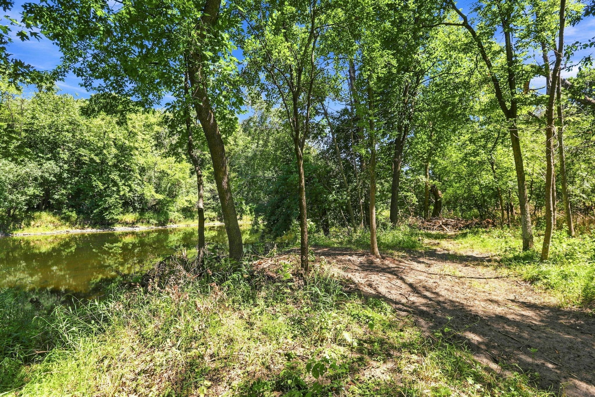 Backyard with mature trees overlooking the river
