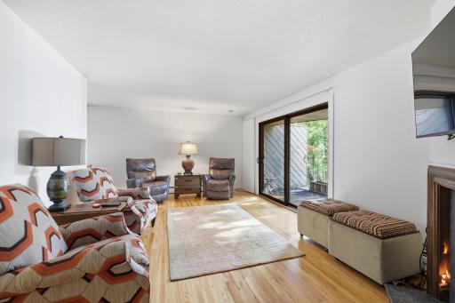 Sun filled living room with gleaming hard wood floors