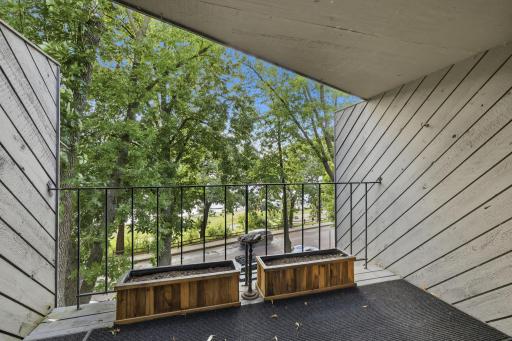 Private, covered patio/deck looks out to the lake and the TREES!
