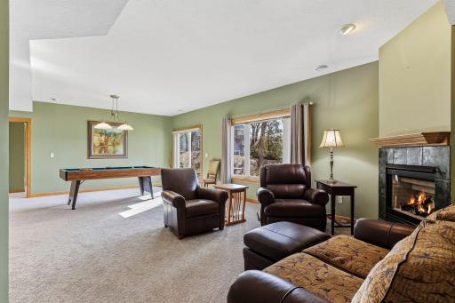 Warm and welcoming family room anchored by a. tiled gas fireplace