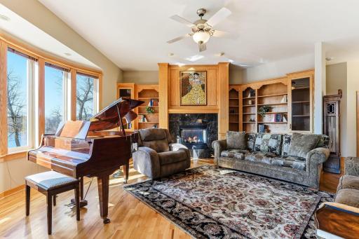 Striking custom oak cabinetry commands the living room.