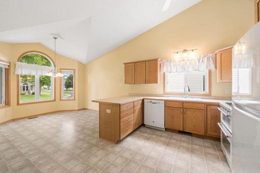 Open kitchen with vaulted ceilings and eat-in kitchen.