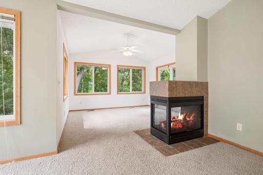 3-sided fireplace looking towards sunroom