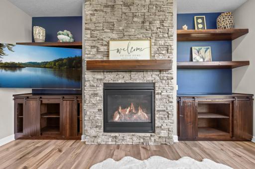 Floor to ceiling fireplace with stone surround