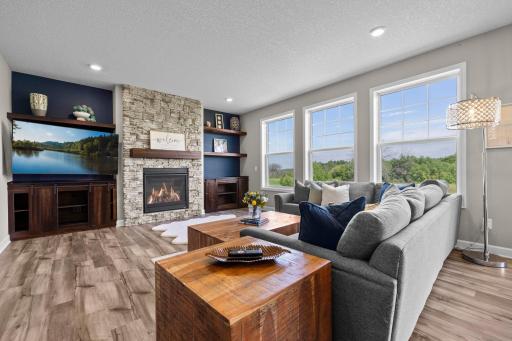 Gorgeous stone surround gas fireplace, wall of windows and the view are showstoppers!