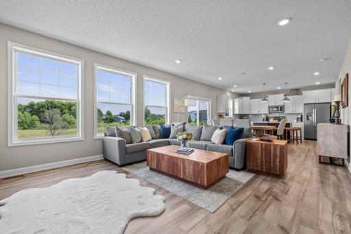 Spacious living area and wall of windows with a great meadow and treed view!