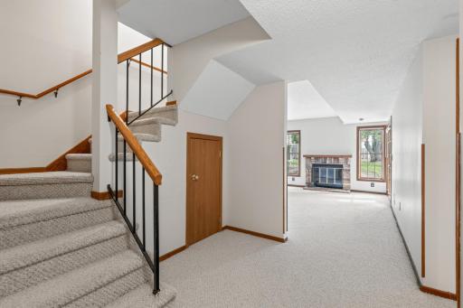 At the bottom of the basement stairs, looking into the open family room
